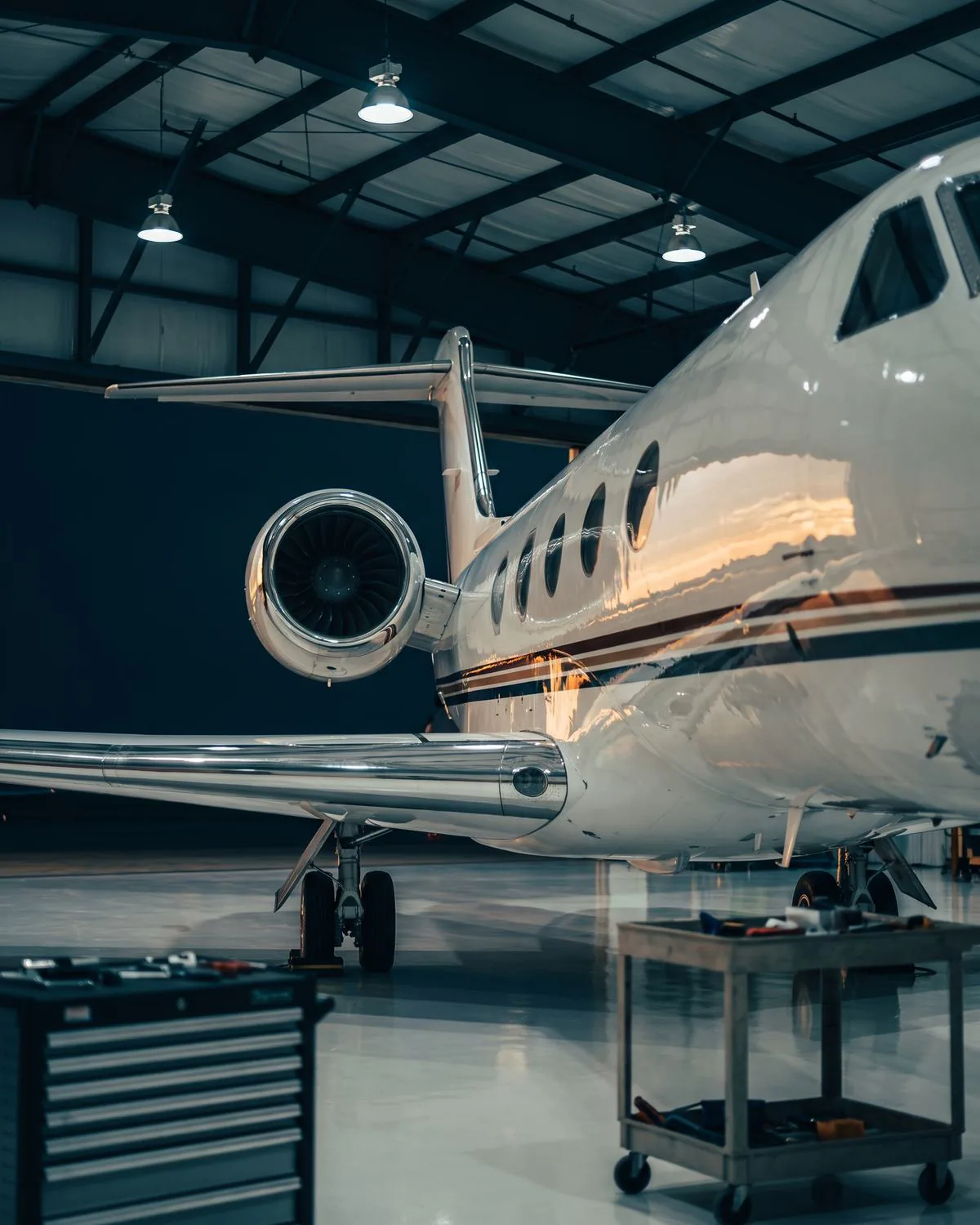 Business jet parked inside a private hangar